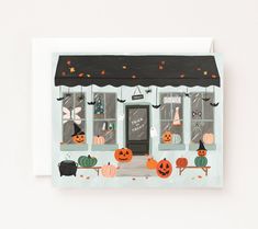 a greeting card with an image of a store front decorated in halloween pumpkins and bats