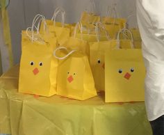 small yellow bags with faces on them sitting on a table