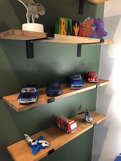 three wooden shelves with toy cars on them