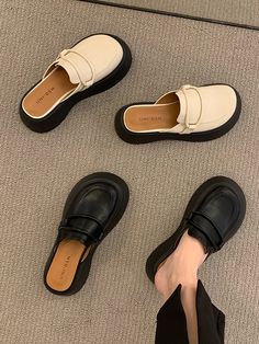 three pairs of black and white shoes on the floor