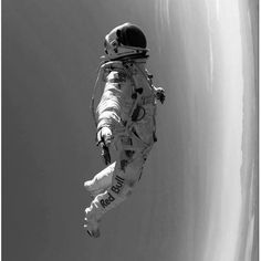 an astronaut floating in the air with his feet up