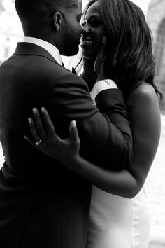 a black and white photo of a couple embracing