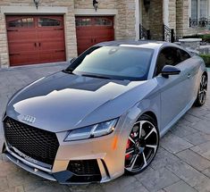 a silver car parked in front of a house