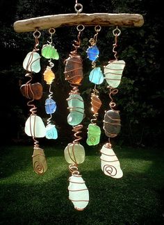 an image of a mobile phone with sea glass beads hanging from it's side