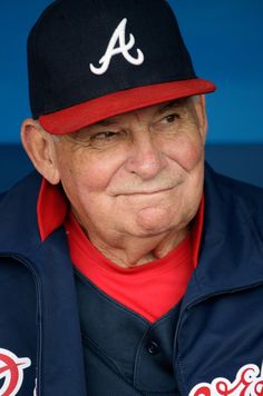 an older man wearing a atlanta braves baseball cap and jacket with the word'a'on it