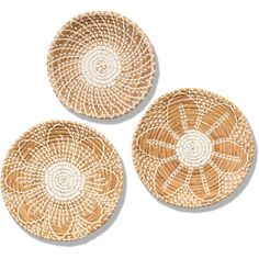 three woven plates with white designs on the top and one has a circular design in the middle