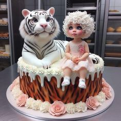 there is a cake with a doll and a tiger on it