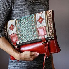 a woman holding a red purse in her hands