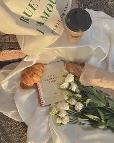 flowers, croissants and coffee are on the ground