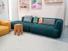 a living room with two couches and a table in front of the couch is made out of wood