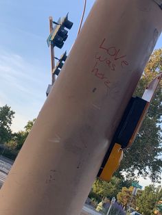 graffiti on the side of a traffic light pole