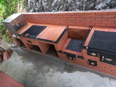 an outdoor grill with three different ovens on it