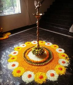 a decorative flower arrangement on the ground in front of a window with stairs leading up to it