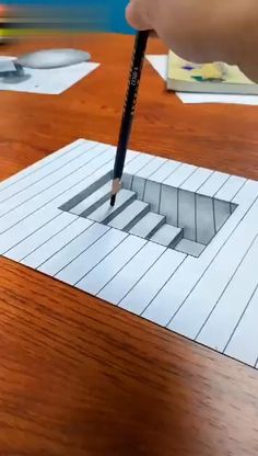 someone is drawing a hole in the floor with pencils