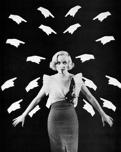 a black and white photo of a woman with her arms outstretched in front of flying birds