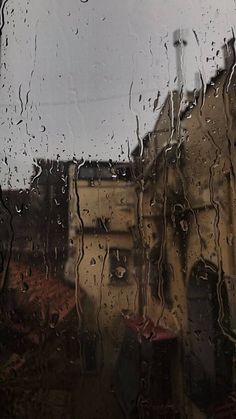 rain drops on the window and buildings in the background