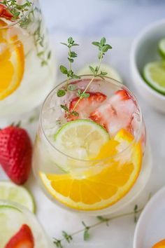 two glasses filled with lemonade and strawberries