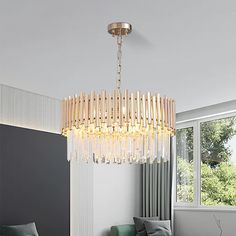 a chandelier hanging from the ceiling in a living room