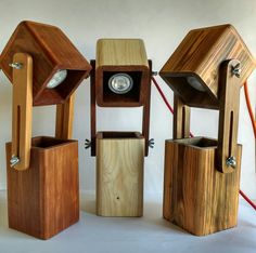 three wooden objects with one light on and the other turned upside down in different positions