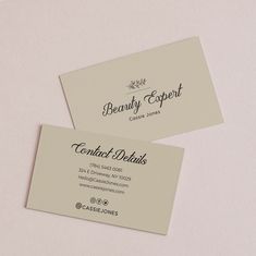 two business cards sitting on top of each other next to an envelope with the words beauty expert