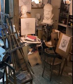 an artist's studio with sculptures and paintings on easels in the foreground