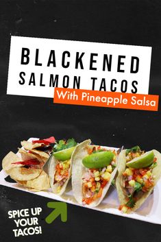 three tacos with pineapple salsa and black eyed salmon are on a white plate