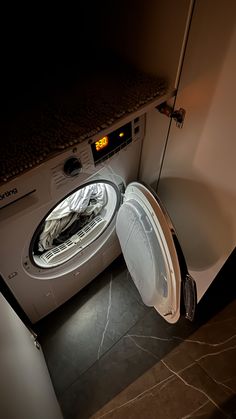 a washing machine with its door open in a room