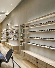the inside of a store with many shelves filled with sunglasses and other items on display