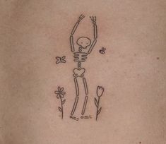 a skeleton with flowers and butterflies on the back of a woman's stomach is depicted in this tattoo design