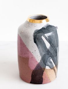 a ceramic vase with an abstract design on it