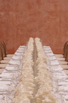 a long table with white frosted food on it