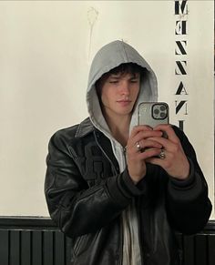 a young man taking a selfie with his cell phone