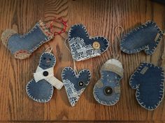 several pieces of denim heart shaped ornaments on a wooden table