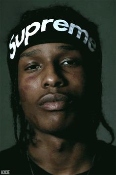 a man wearing a supreme hat with the word supreme on it's headband
