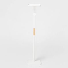 a white stand with a wooden stick sticking out of it's side on a white background