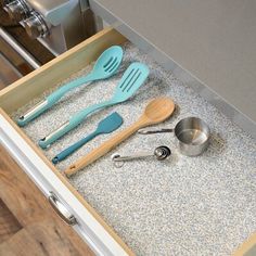 a drawer with utensils and spoons in it