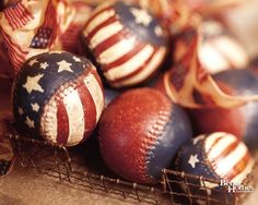 a basket filled with baseballs covered in stars and stripes on top of a table