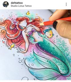 someone is drawing a mermaid with colored pencils