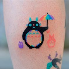 a close up of a person's legs with tattoos on them and an animal holding an umbrella