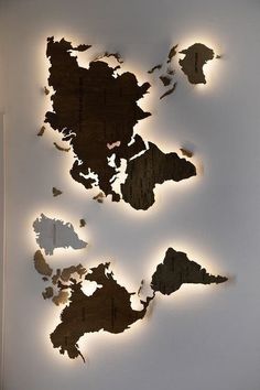 three pieces of wood that have been cut into the shape of an island and are lit up with lights