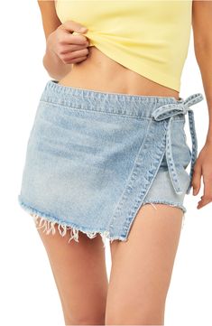 This supercute light-wash skort with raw hems closes with a little tie at the hip. 2 1/2" inseam; 28" leg opening; 12 1/2" front rise; 15 1/2" back rise (size 8) 100% cotton Machine wash, tumble dry Imported Outfit Wishlist, Jean Skort, Denim Skort, Zach Bryan, Concert Fits, Country Concerts, Tie Wrap, Gameday Outfit, Crop Top Sweater