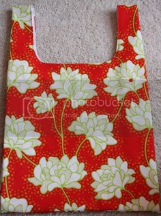 a red bag with white flowers on it