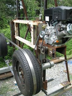 an engine is attached to the side of a trailer with wheels and chains on it