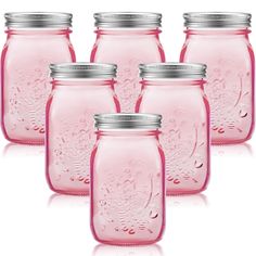 six pink mason jars with silver lids