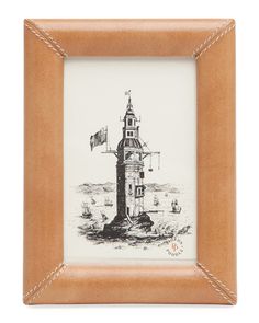 a wooden frame with a black and white drawing of a lighthouse in the ocean on it