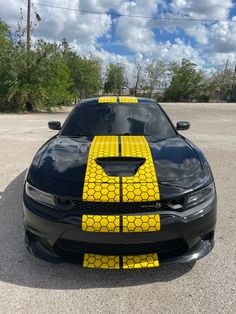 a black car with yellow stripes on it