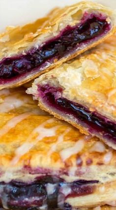 three blueberry pastries stacked on top of each other