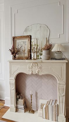 a living room with a fireplace and pictures on the mantle