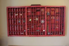 a wall mounted jewelry rack with earrings on it