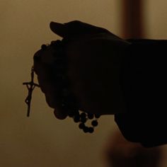 a person holding a rosary in their hand